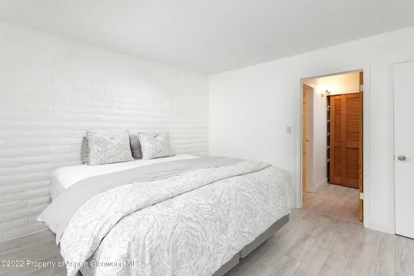 a bedroom with a bed and a night stand