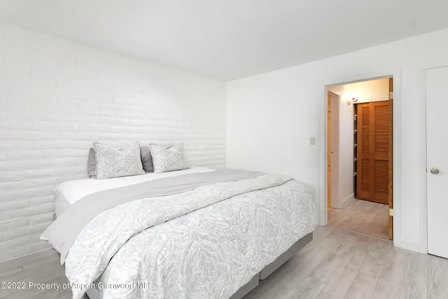 a bedroom with a bed and a night stand