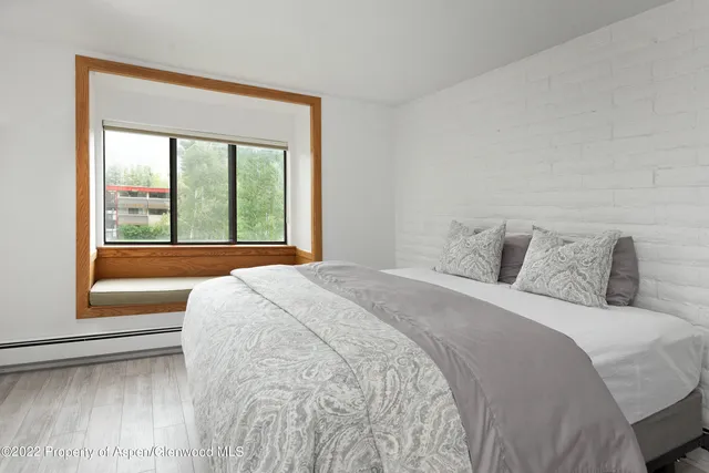 a bedroom with a large bed and a large window