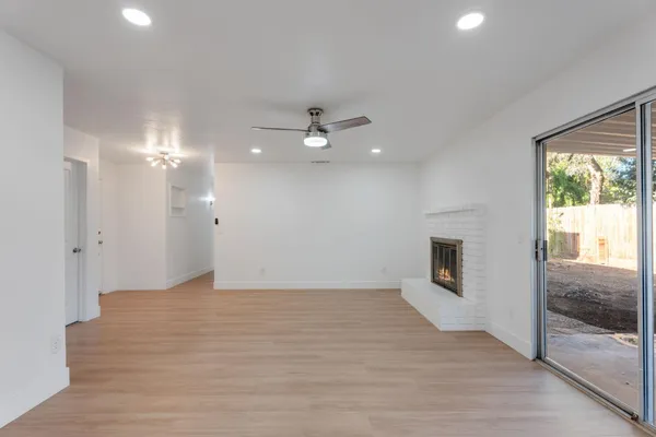 a view of an empty room with a fireplace