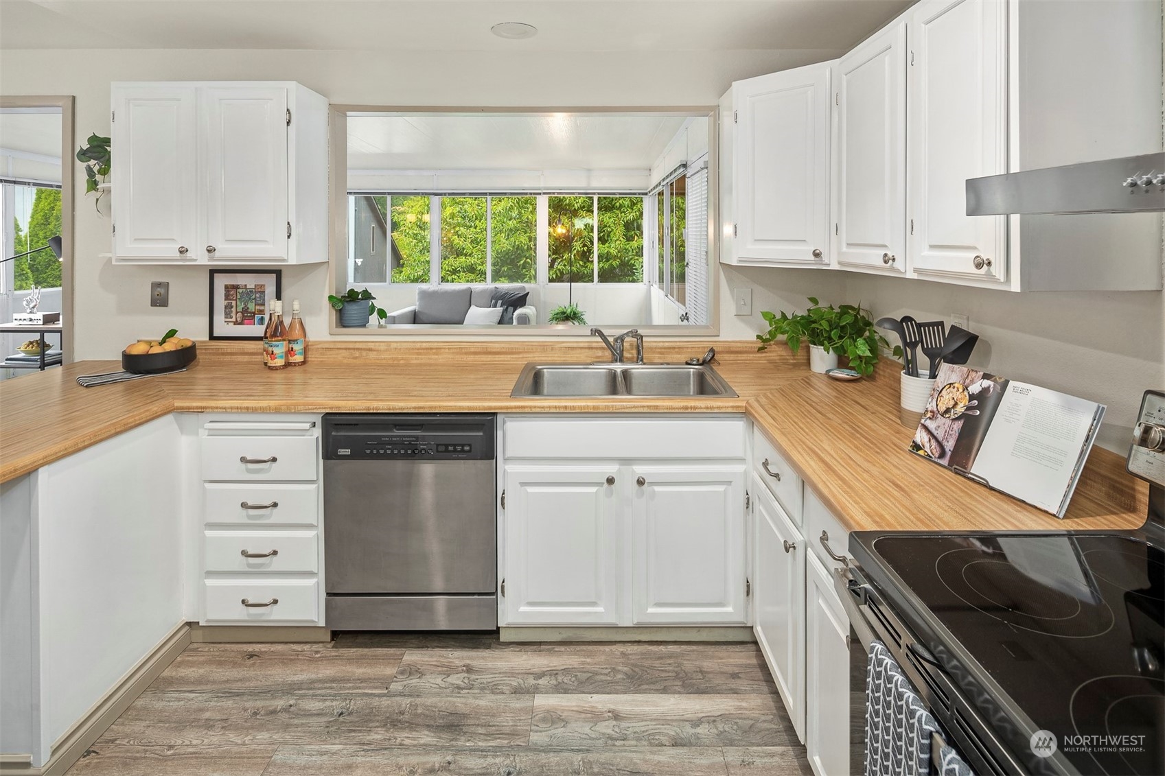 10026 Southeast 192nd Street Renton, WA 98055 - Photo 10 of 34 a kitchen with a white stove top oven sink and cabinets