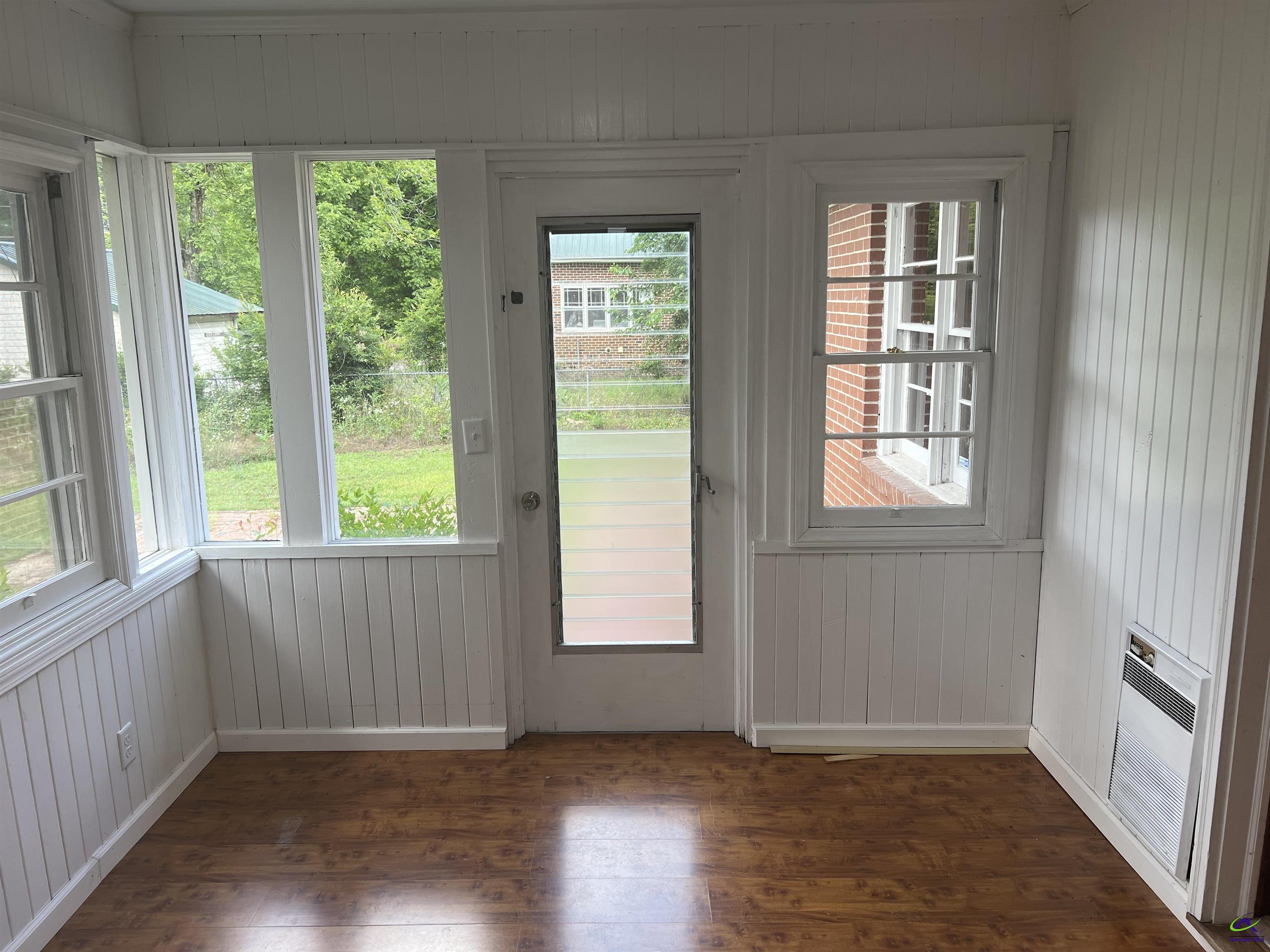 145 South 2nd Street Cochran, GA 31014 - Photo 15 of 24 an empty room with wooden floor and windows