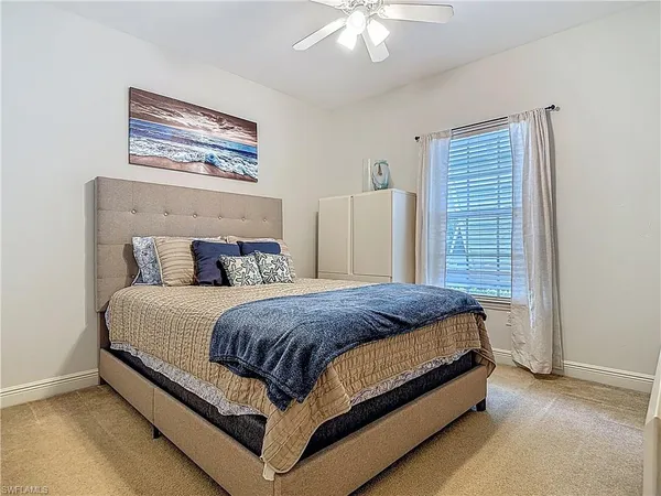 a bed sitting in a bedroom next to a window