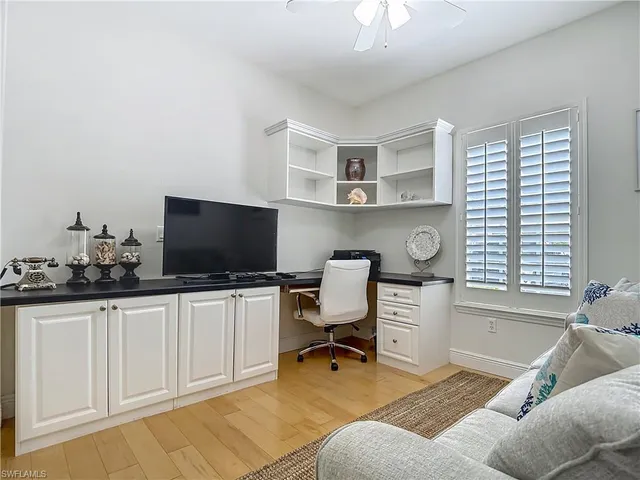 a view of a livingroom with workspace and a window