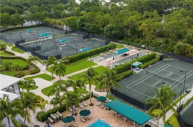 a living room with furniture a chandelier and a dining table