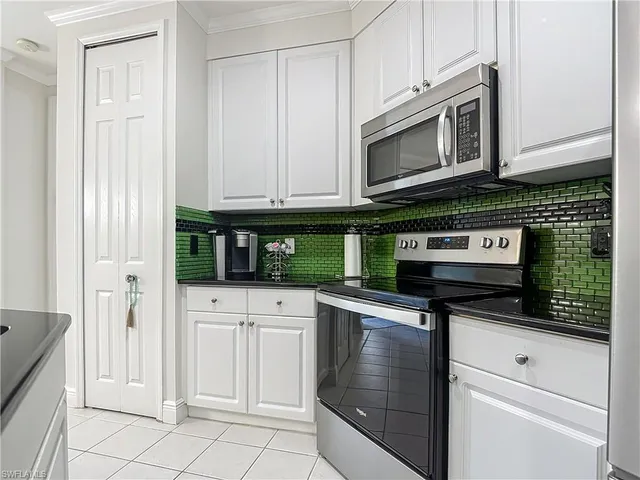 a kitchen with stainless steel appliances granite countertop a stove and a microwave