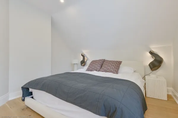 a bedroom with a bed and lamp