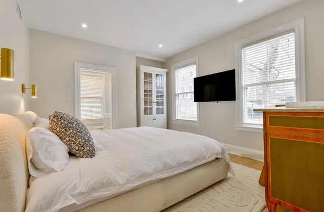 a bedroom with a bed and a flat screen tv