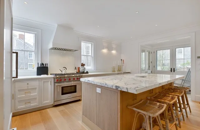 a kitchen with stainless steel appliances granite countertop a stove a sink and a refrigerator