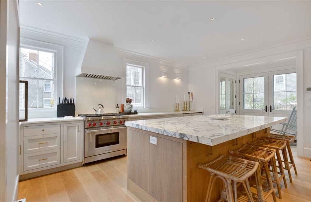 51 Fair Street Nantucket, MA 02554 - Photo 19 of 24 a kitchen with stainless steel appliances granite countertop a stove a sink and a refrigerator