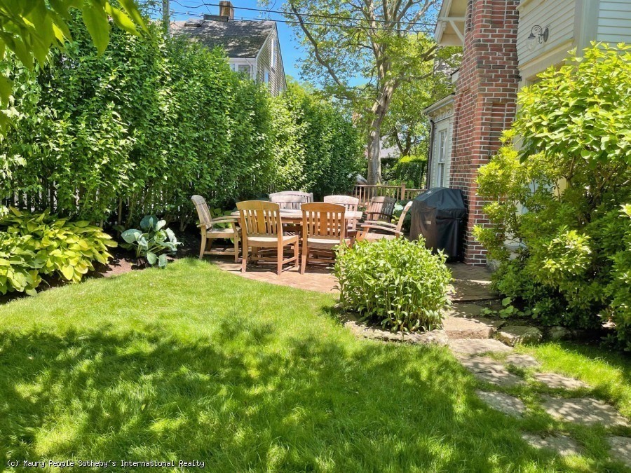 51 Fair Street Nantucket, MA 02554 - Photo 2 of 24 a backyard of a house with yard and outdoor seating