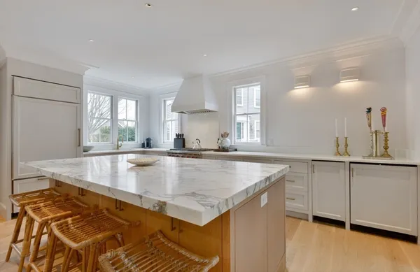 a view of a kitchen counter top space with wooden floor and cabinets