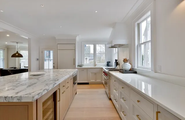 a large bathroom with a granite countertop double vanity sink a bathtub and window
