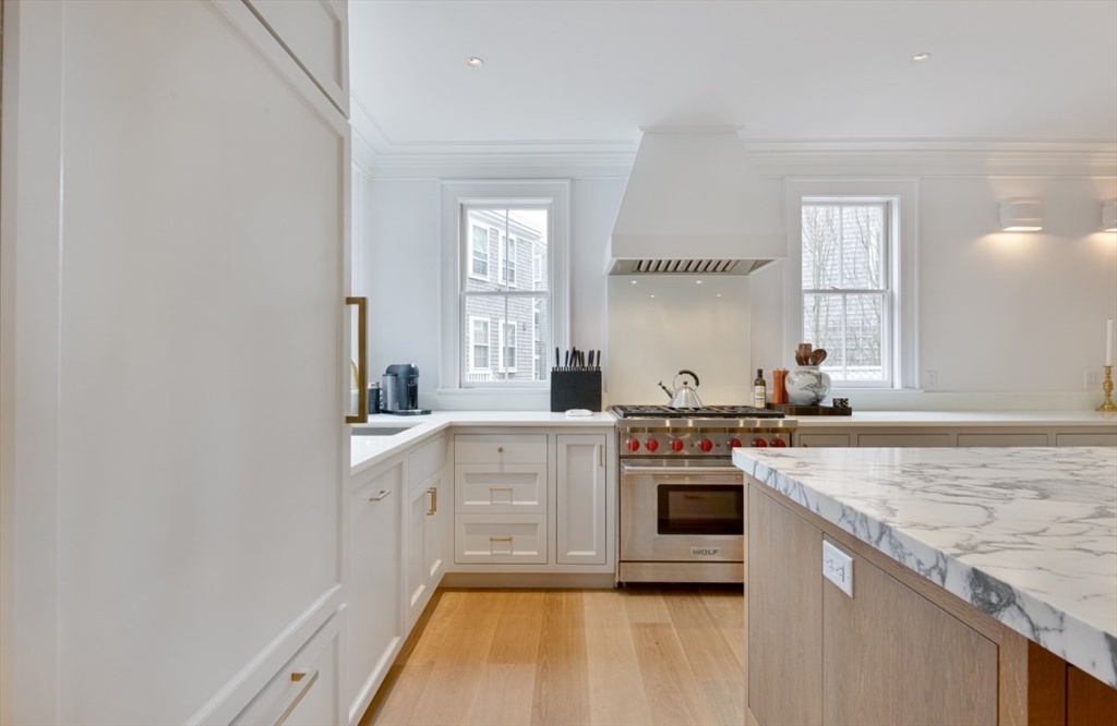 51 Fair Street Nantucket, MA 02554 - Photo 23 of 24 a kitchen with stainless steel appliances granite countertop a stove and white cabinets