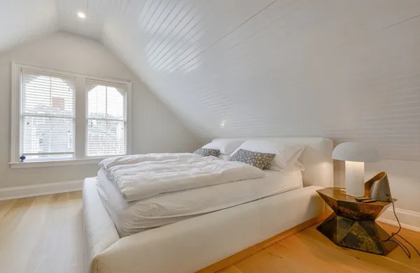 a bedroom with a bed and window