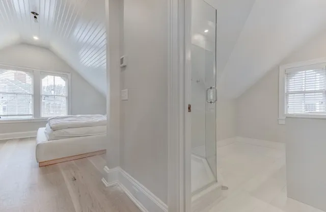 a bathroom with a tub shower and sink
