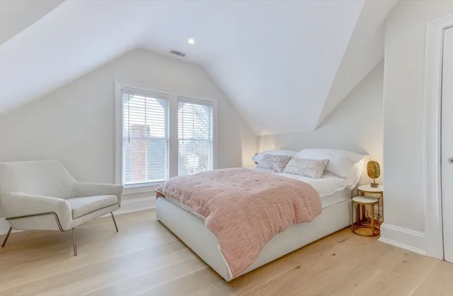 a bedroom with a bed and a couch