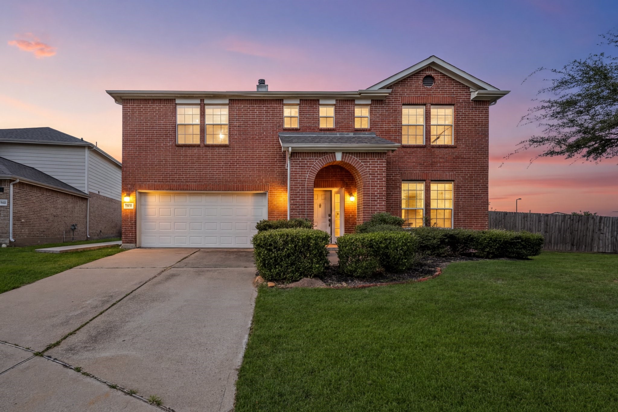 Discover your dream home: a charming brick exterior, spacious interior, and a welcoming atmosphere, all set against a stunning sunset backdrop.
