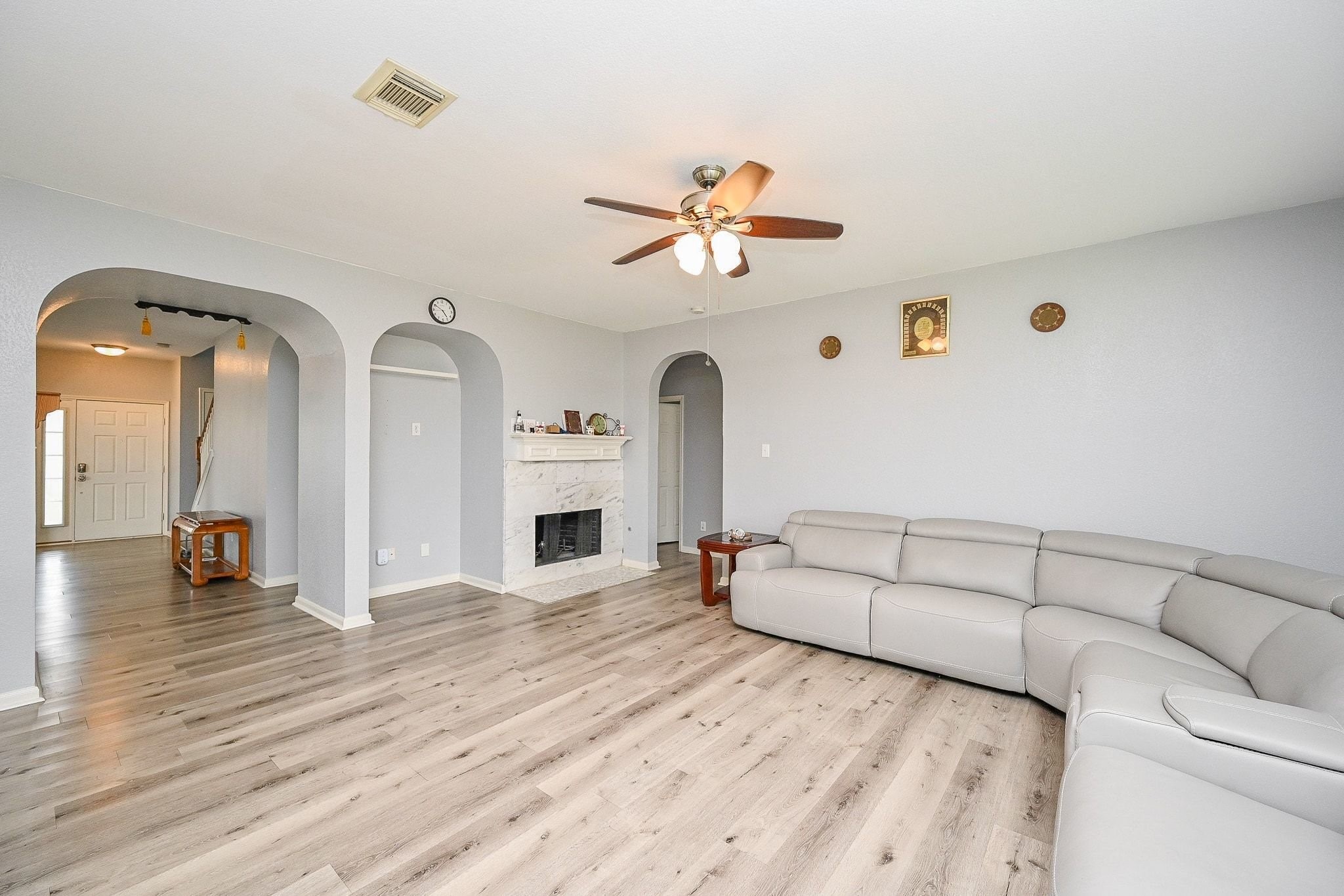 6638 Autumn Sunset Lane Spring, TX 77379 - Photo 12 of 32 Spacious family room featuring elegant flooring, a cozy fireplace, and abundant natural light—perfect for gatherings and relaxation.