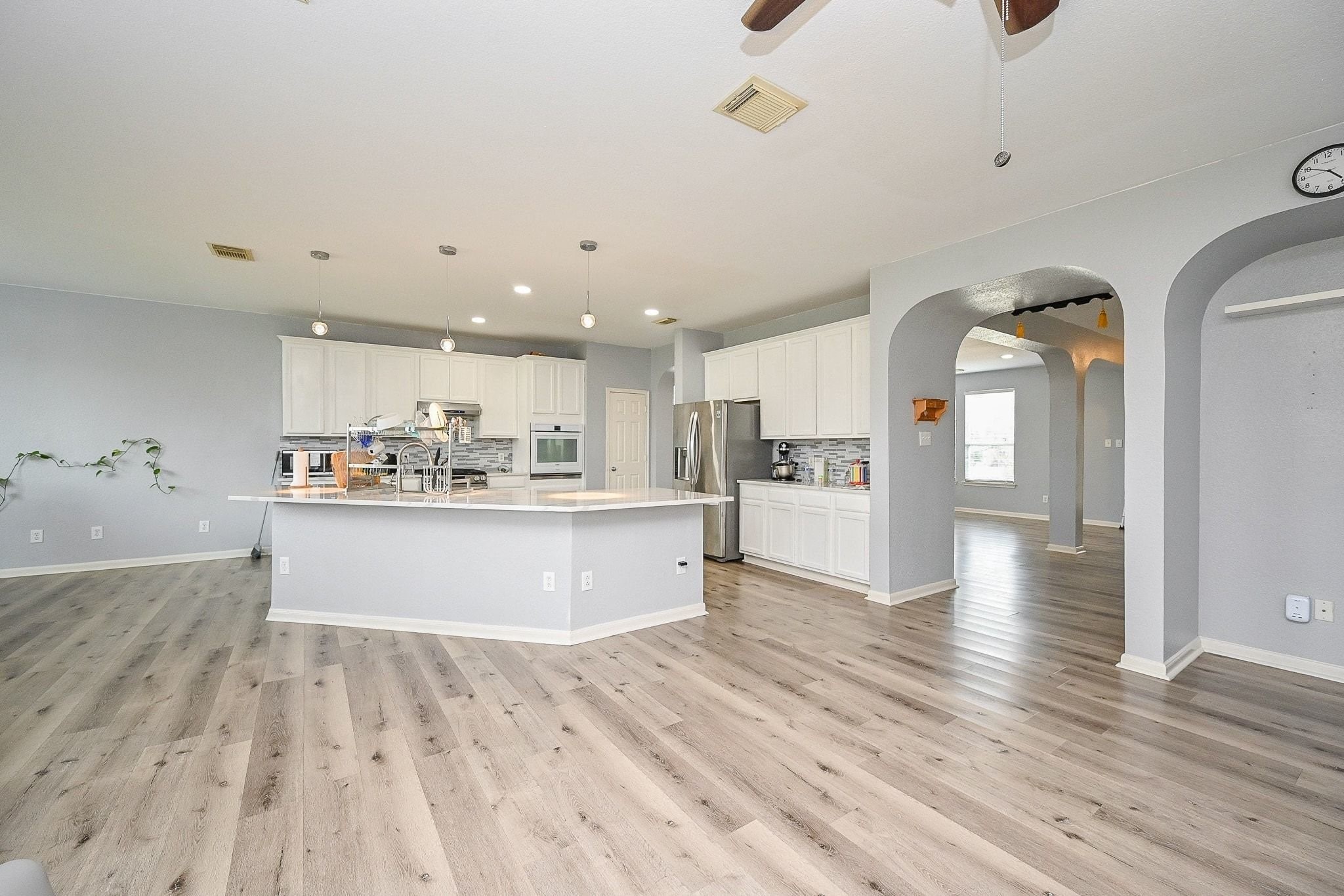 6638 Autumn Sunset Lane Spring, TX 77379 - Photo 13 of 32 Spacious open-concept kitchen and family room featuring modern finishes, sleek cabinetry, and beautiful flooring, perfect for entertaining and family gatherings.