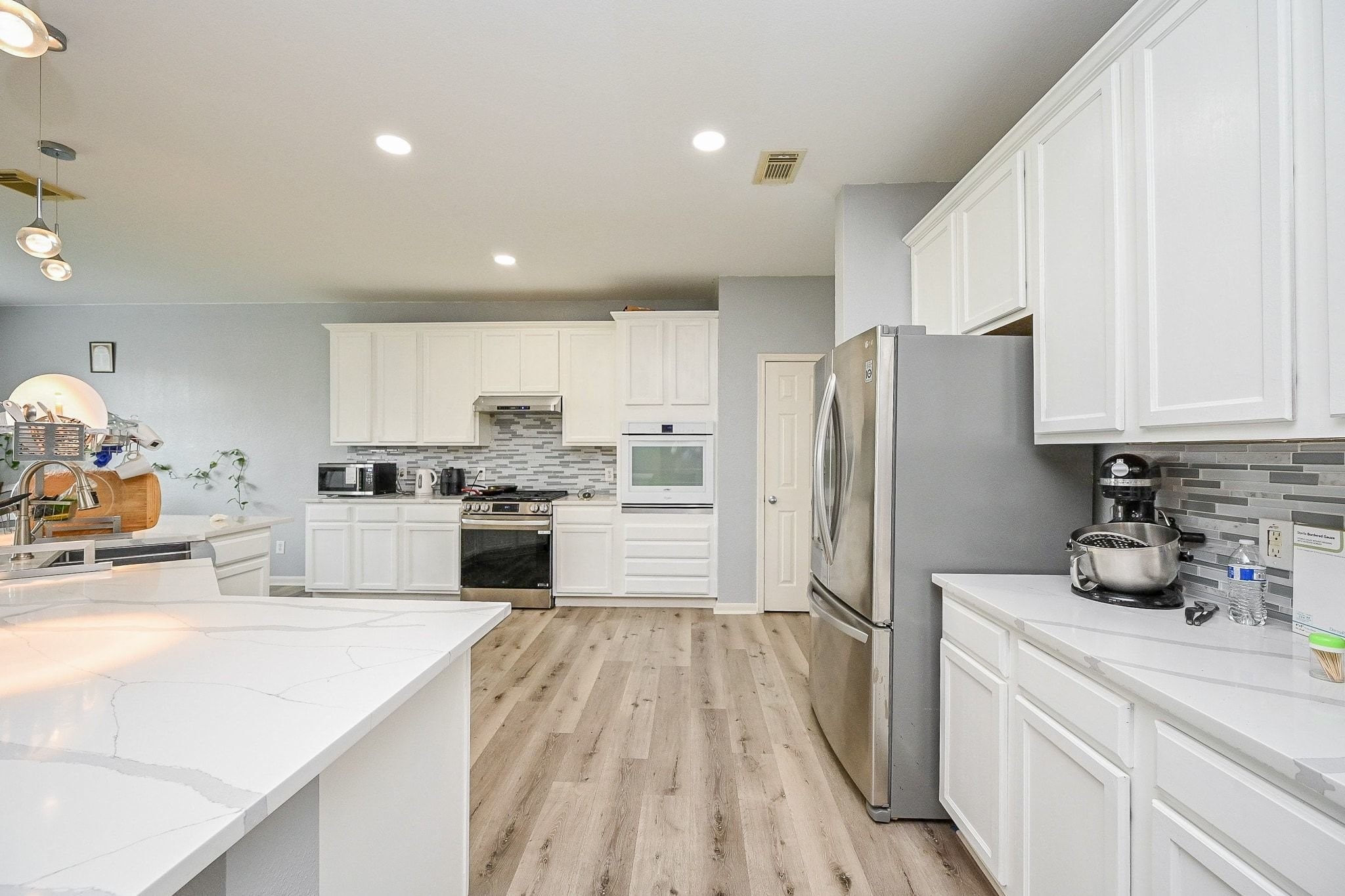 6638 Autumn Sunset Lane Spring, TX 77379 - Photo 14 of 32 Sleek, modern countertops elevate this kitchen with style and functionality.