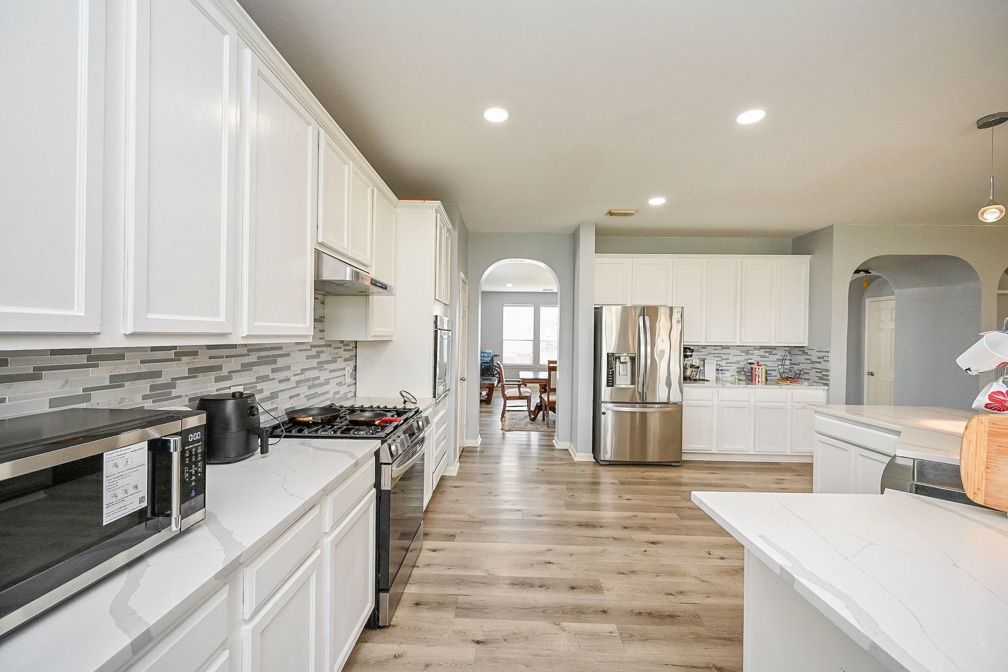 6638 Autumn Sunset Lane Spring, TX 77379 - Photo 15 of 32 Sleek kitchen with modern appliances flows seamlessly into a bright dining area, perfect for entertaining.