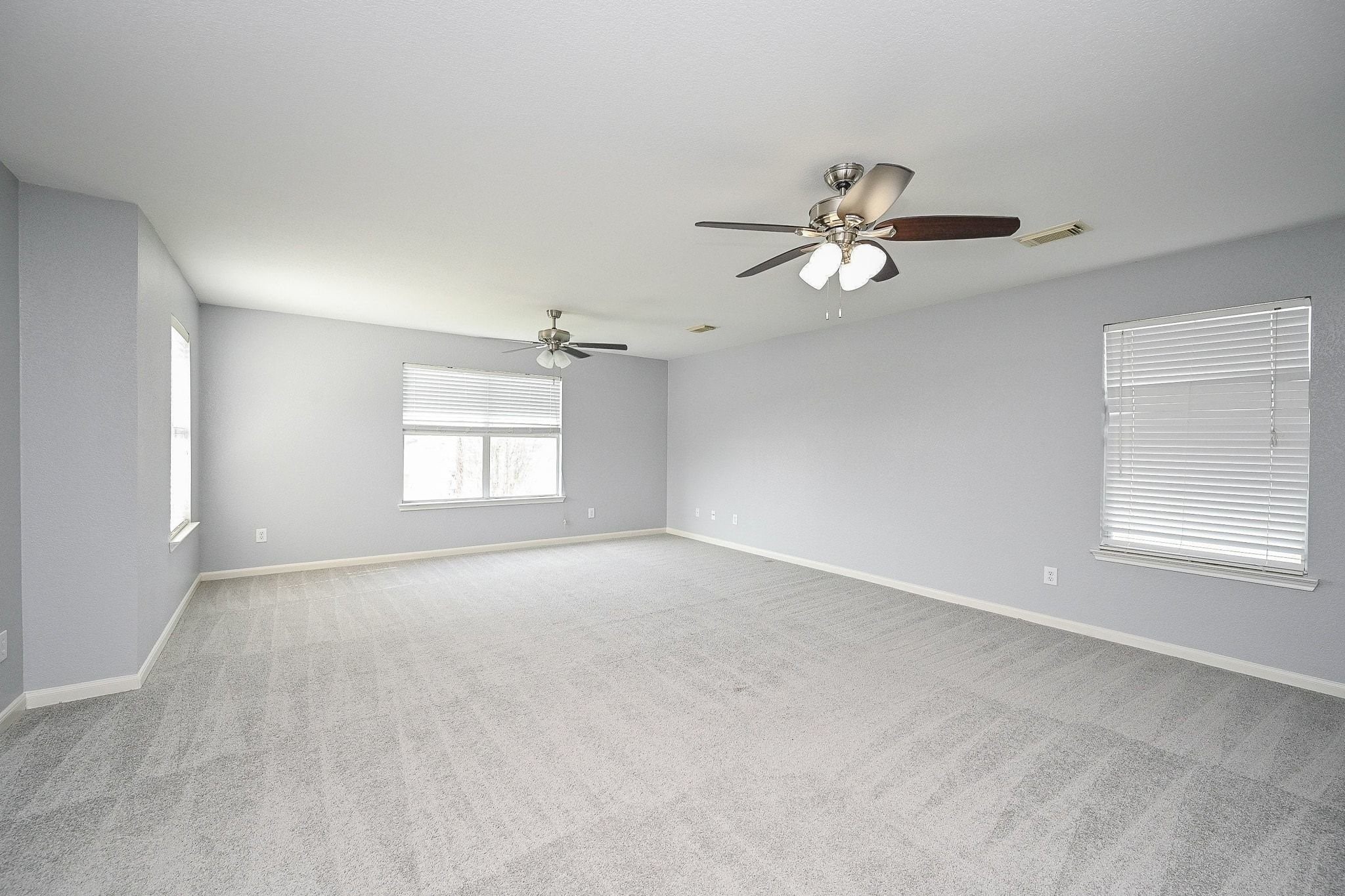 6638 Autumn Sunset Lane Spring, TX 77379 - Photo 17 of 32 Spacious primary bedroom filled with abundant natural light.