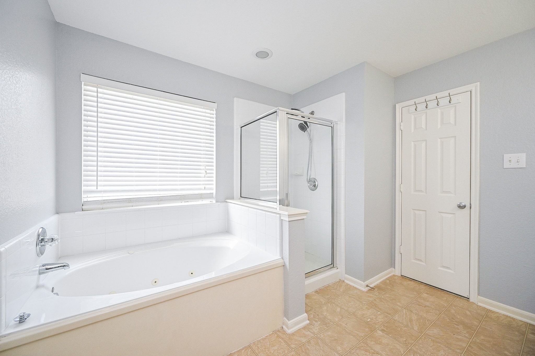 6638 Autumn Sunset Lane Spring, TX 77379 - Photo 20 of 32 Bright and spacious primary bathroom featuring a luxurious bathtub and a sleek glass shower.