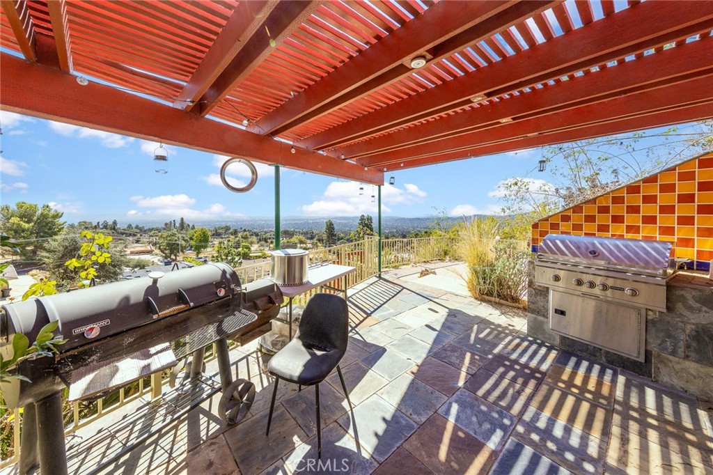 591 Devonwood Road Altadena, CA 91001 - Photo 15 of 35 a view of a patio with a table and chairs