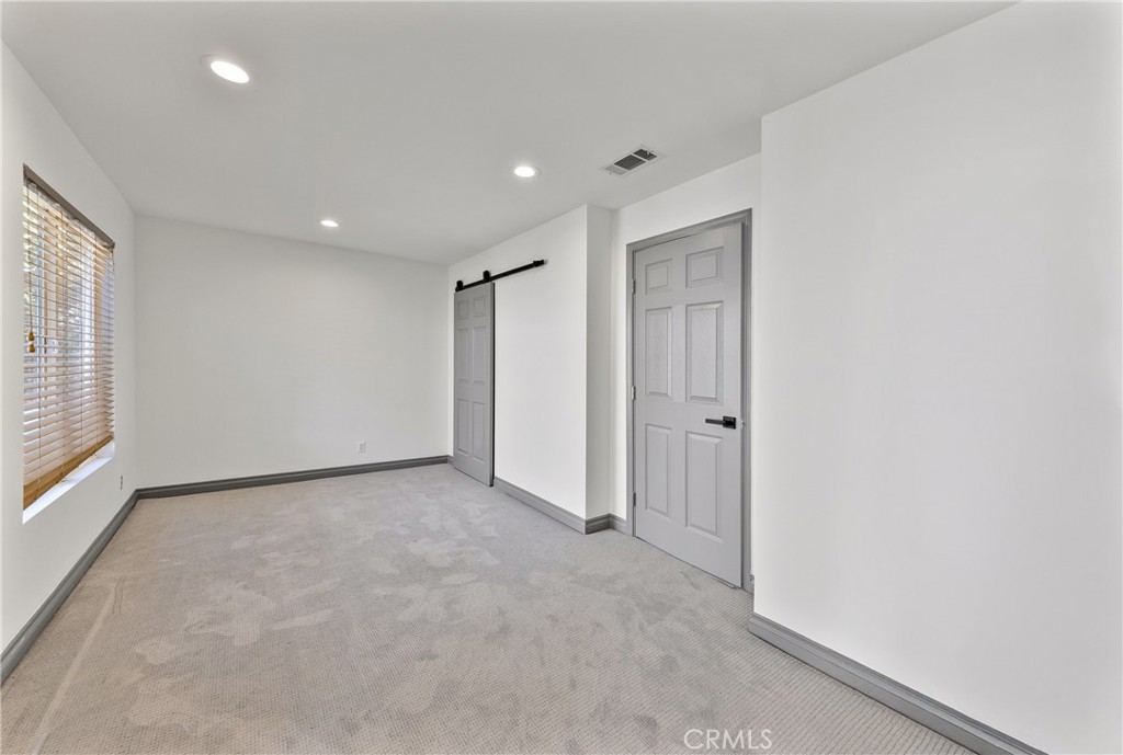 591 Devonwood Road Altadena, CA 91001 - Photo 26 of 35 an empty room with closet and windows