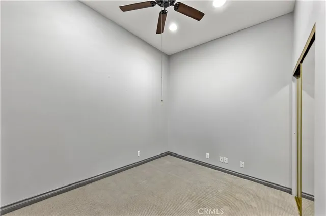 an empty room with windows and closet