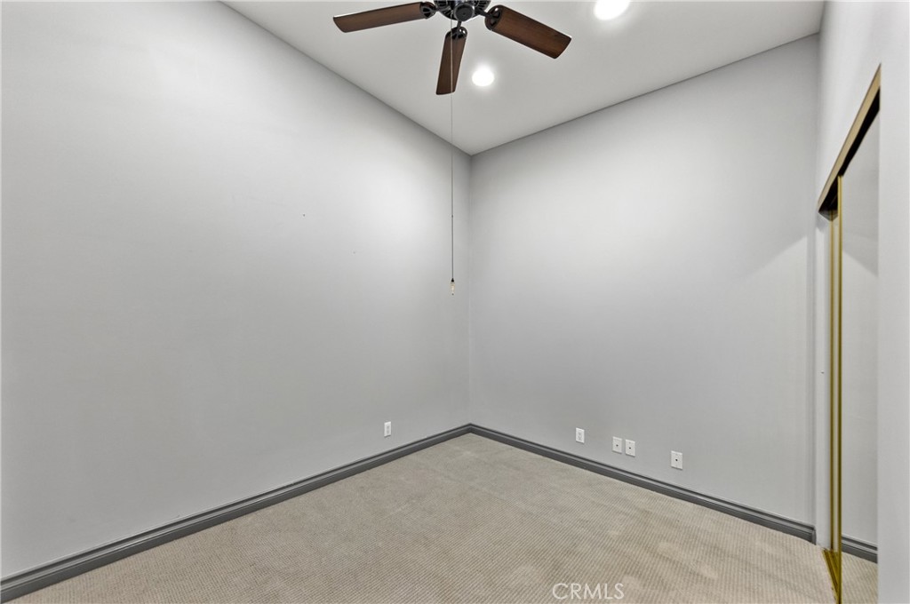 591 Devonwood Road Altadena, CA 91001 - Photo 28 of 35 an empty room with a ceiling fan and carpet