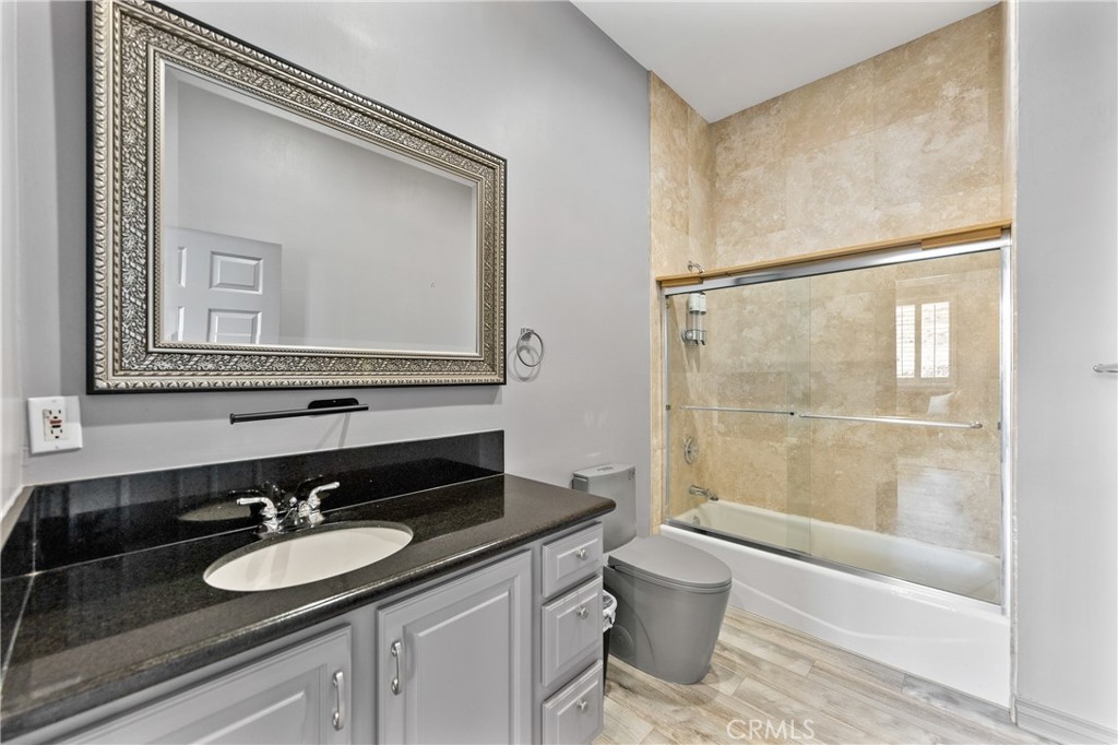 591 Devonwood Road Altadena, CA 91001 - Photo 31 of 35 a bathroom with a granite countertop sink toilet and shower