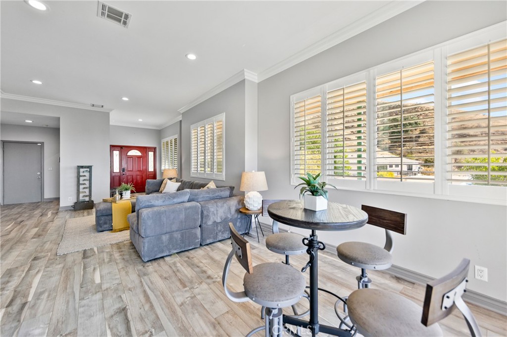 591 Devonwood Road Altadena, CA 91001 - Photo 8 of 35 a living room with fireplace furniture and a wooden floor