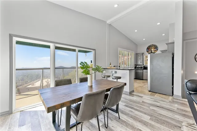 a view of a dining room with furniture and a potted plant