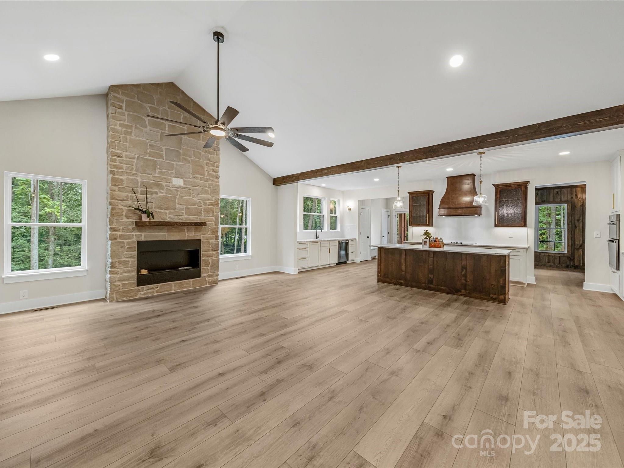 110 Rupard Road Statesville, NC 28625 - Photo 13 of 45 a view of a livingroom with a fireplace a ceiling fan a fireplace and windows