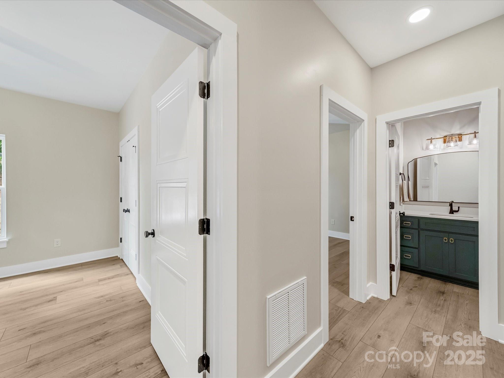110 Rupard Road Statesville, NC 28625 - Photo 20 of 45 a view of a bathroom with sink mirror and wooden floor
