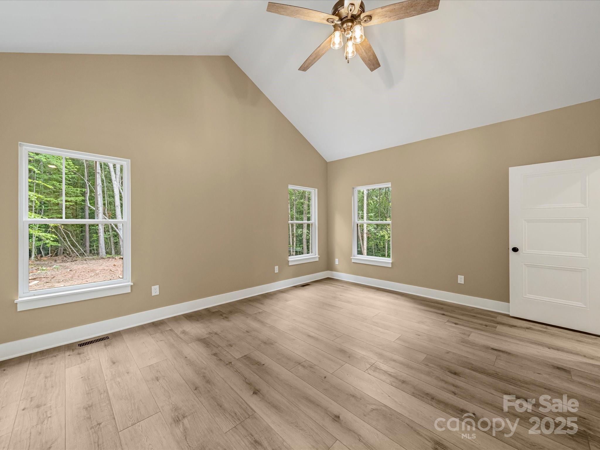 110 Rupard Road Statesville, NC 28625 - Photo 27 of 45 a view of an empty room with wooden floor and a window