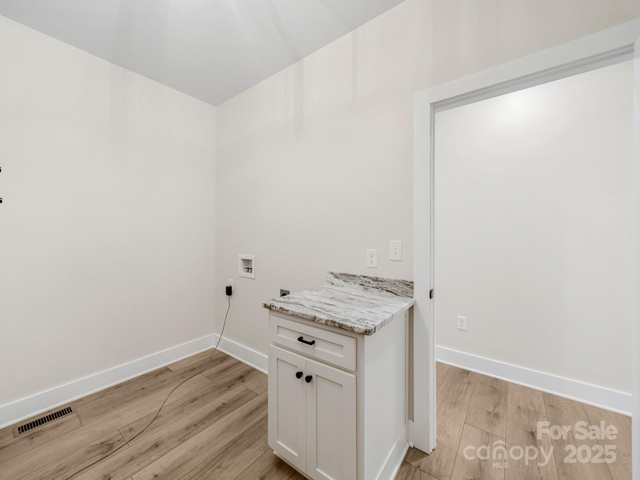110 Rupard Road Statesville, NC 28625 - Photo 41 of 45 a view of a storage and utility room with wooden floor