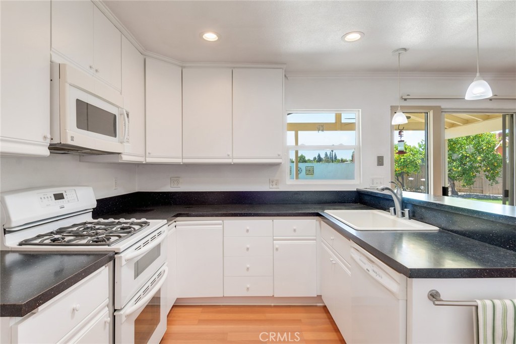9130 Duncan Avenue Riverside, CA 92503 - Photo 10 of 34 a kitchen with granite countertop a sink stove top oven and cabinets