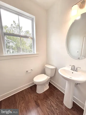 a bathroom with a sink toilet and a mirror