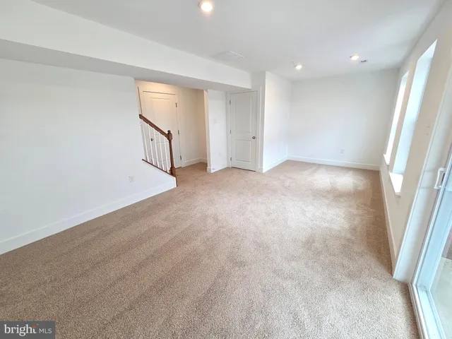 an empty room with entrance and windows