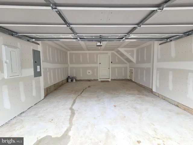 a front view of a building with a garden