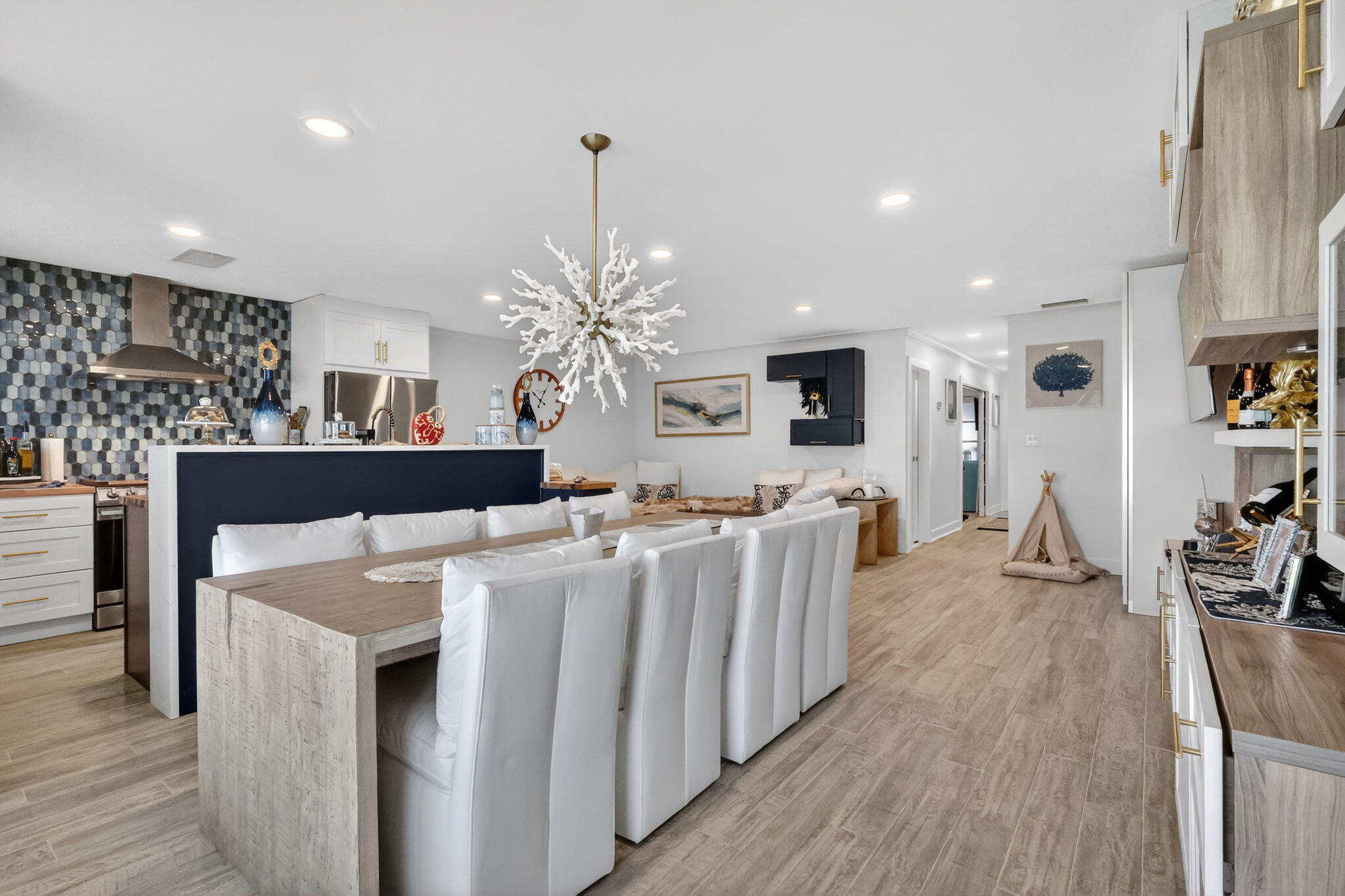 a living room with kitchen island furniture and a chandelier