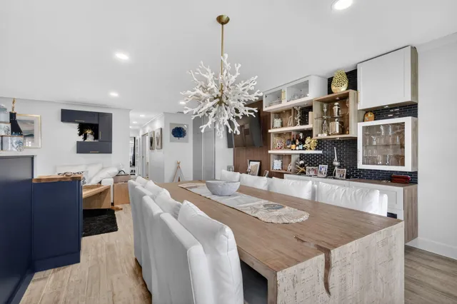 a living room with kitchen island furniture and a chandelier