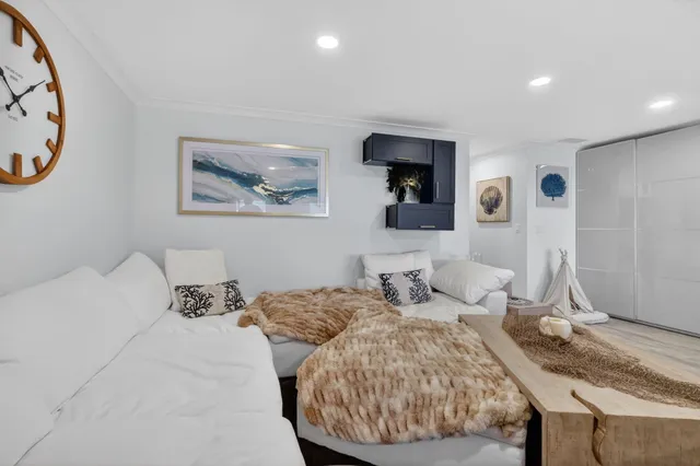 a bedroom with a bed and a painting on the wall