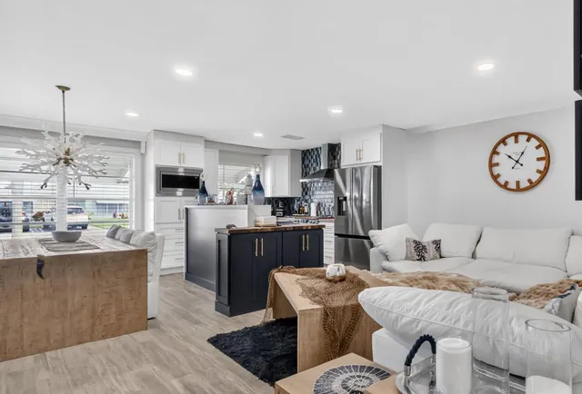 a living room with furniture and kitchen view
