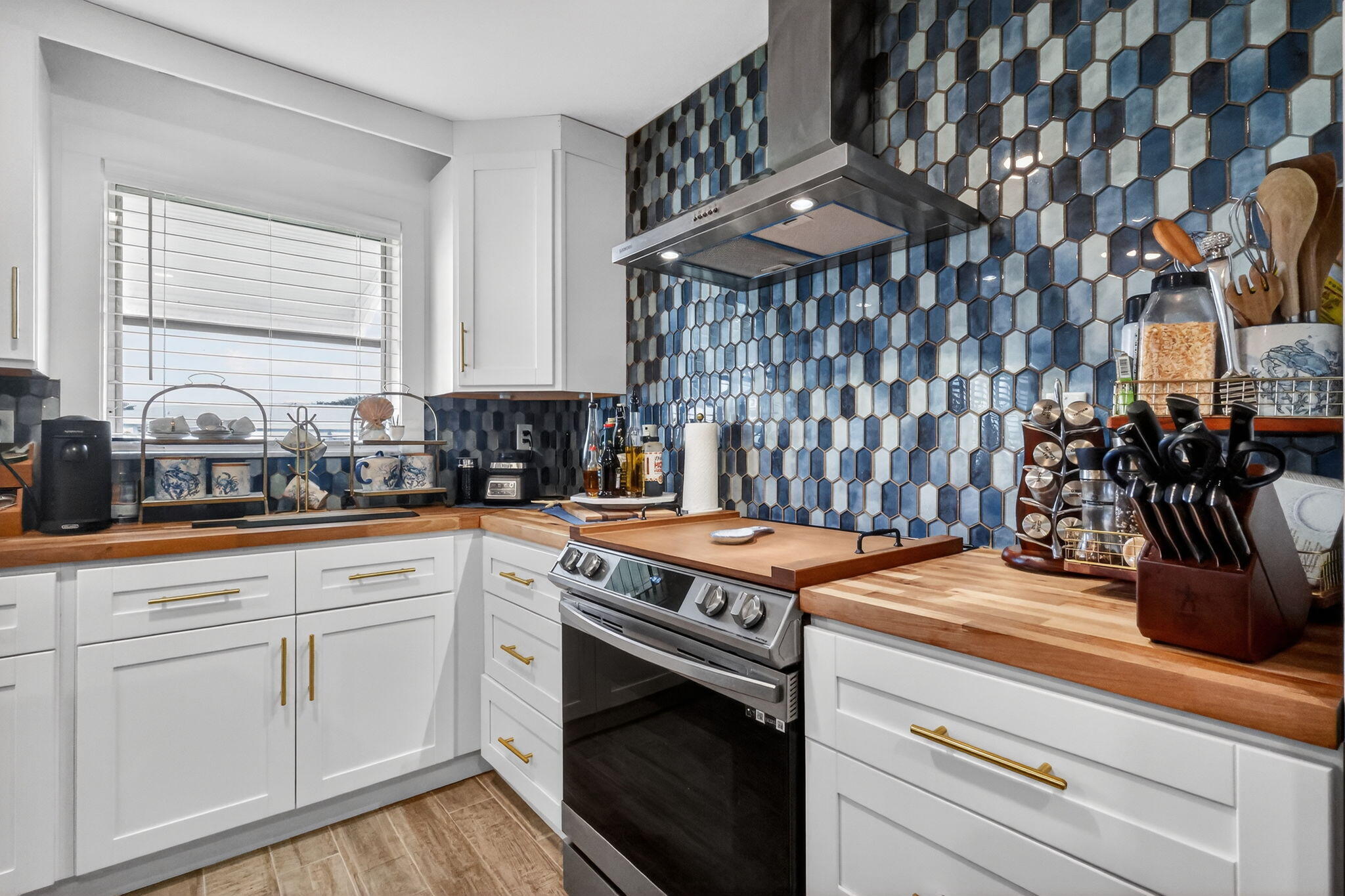 212 West High Point Terrace, Unit C Delray Beach, FL 33445 - Photo 17 of 35 a kitchen with a stove and white cabinets