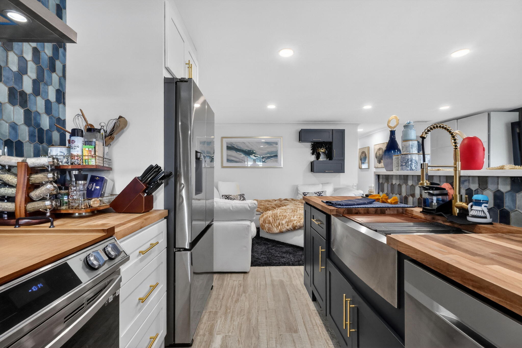 212 West High Point Terrace, Unit C Delray Beach, FL 33445 - Photo 19 of 35 a kitchen with stainless steel appliances granite countertop a sink stove and cabinets