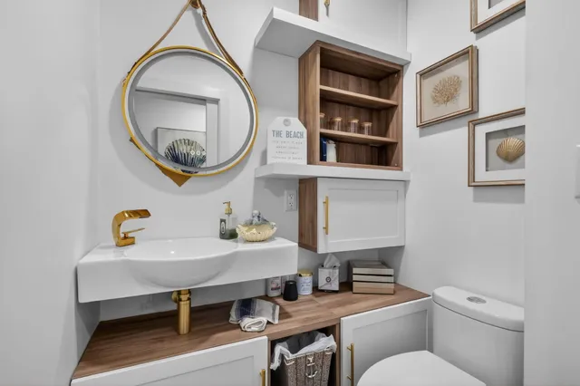 a bathroom with a toilet a sink and a mirror